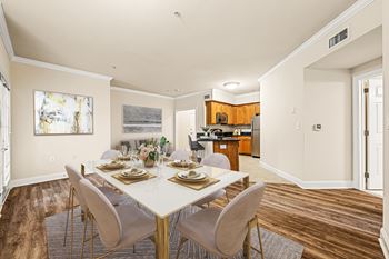 A dining room with a table set for six people.